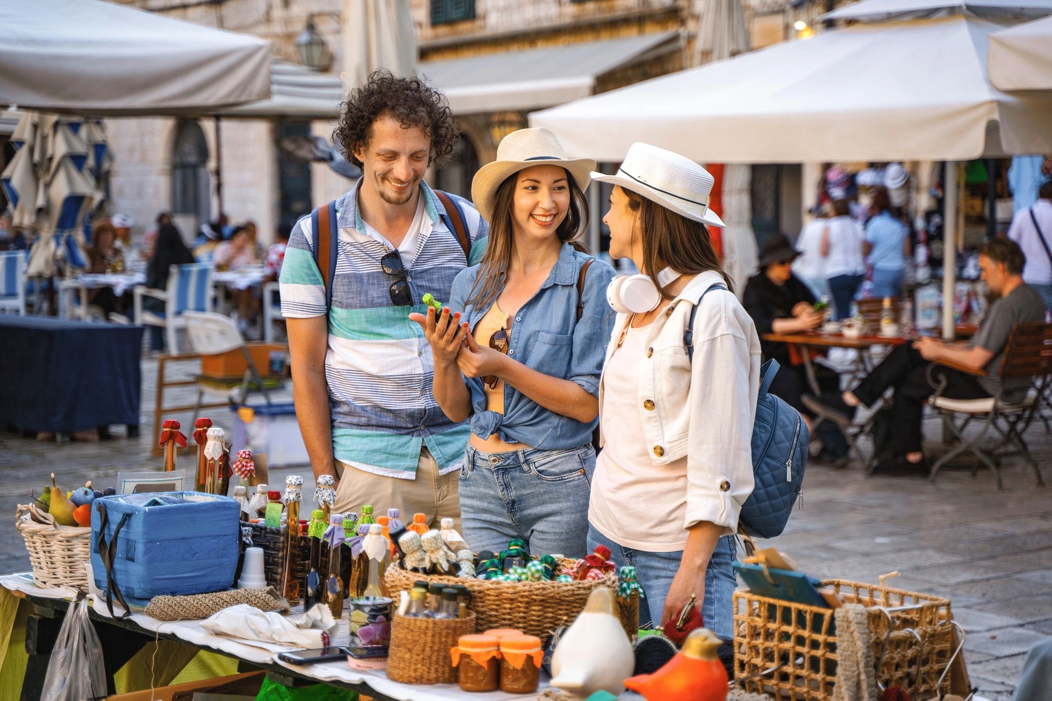 Shoppers browsing handmade goods at an outdoor market