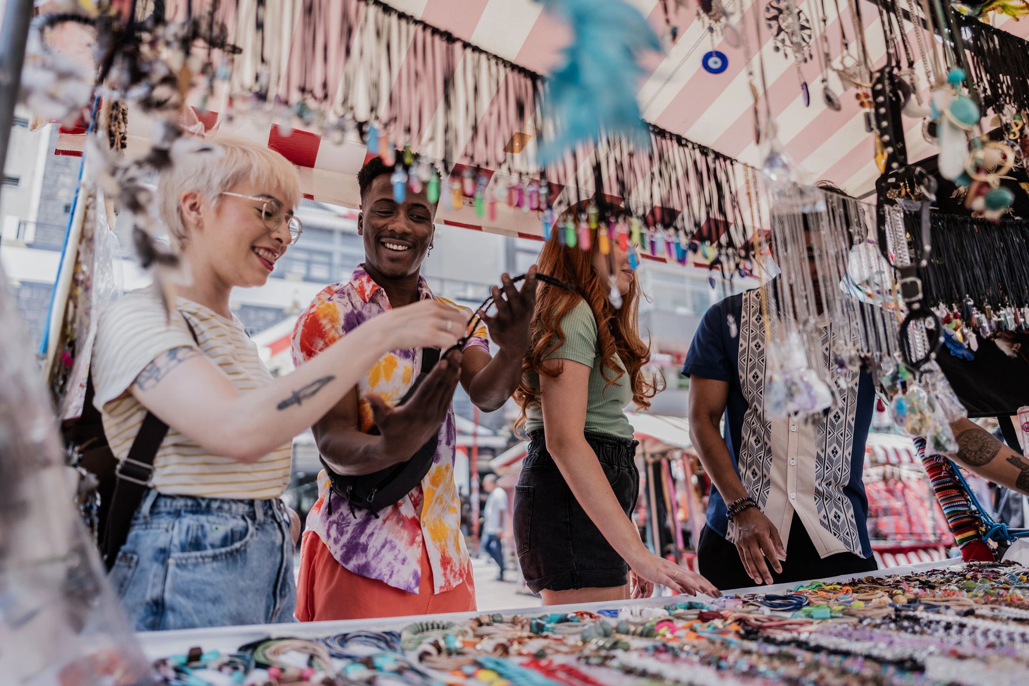 Friends shopping for handmade items at a street market