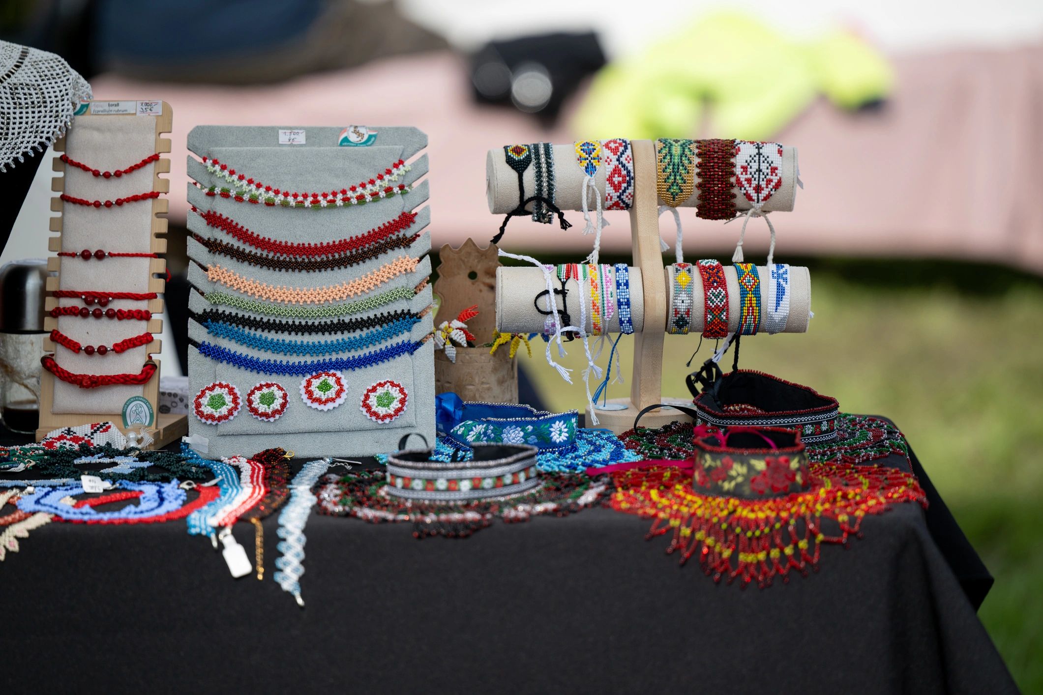 Handmade beaded jewelry displayed on a market table